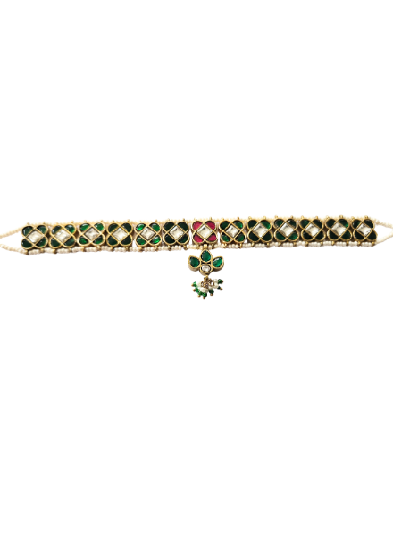 Gold bracelet with green and red stones 