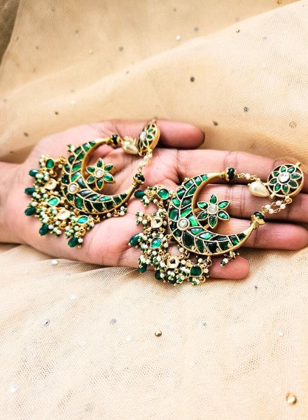 Green earings Woman holdng In hand