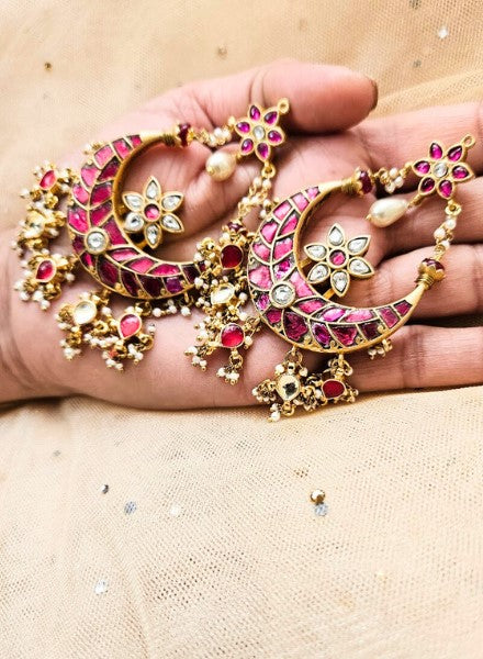 Pink earings woman holding in hands