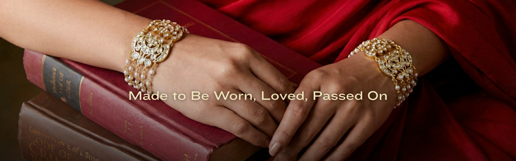 Close-up of hands wearing gold bracelets 