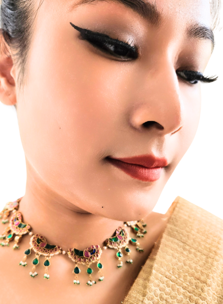 Close-up of a woman wearing an ornate necklace 