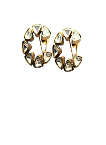 A pair of half moon kundan earrings with gold metal and studded with small diamond-like crystals.