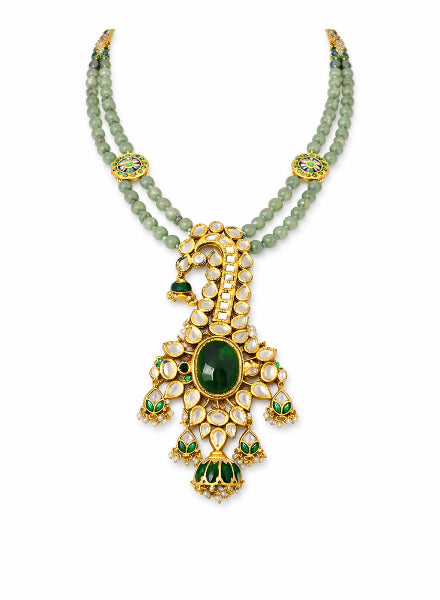 Jewelry set with green gemstones and gold accents 