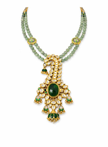 Jewelry set with green gemstones and gold accents 