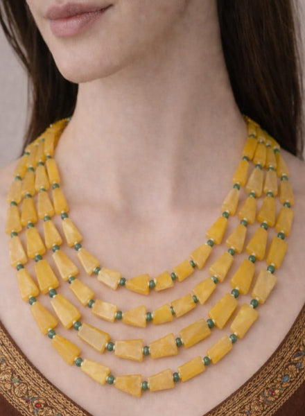 Yellow beaded necklace worn by a model