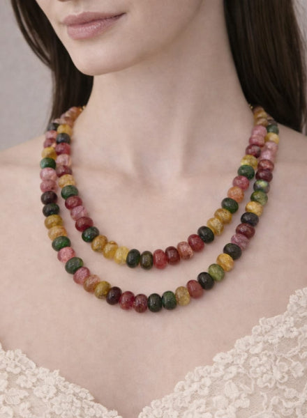 Multicolored beaded necklace worn by a model against 